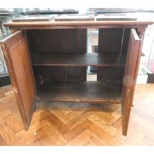 802 - A 19th century framed mahogany two door cabinet with turned pilasters to the sides