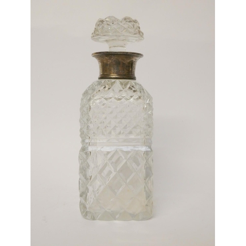 537 - A square cut glass decanter with silver rim