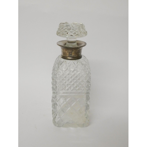 537 - A square cut glass decanter with silver rim