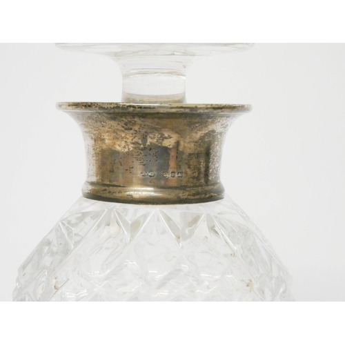 537 - A square cut glass decanter with silver rim