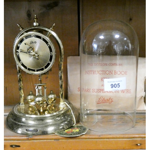 539 - A Schatz brass 400 day clock and a dome