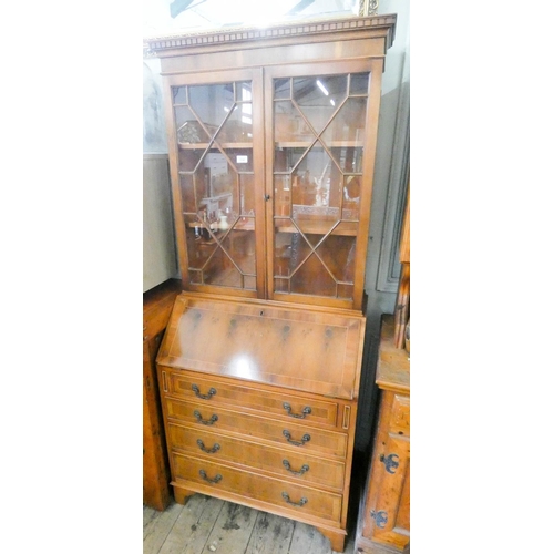 114 - A reproduction yew wood lattice glazed bureau bookcase with four drawers under, 2'6 wide