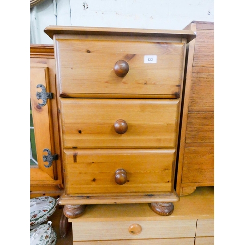 122 - A pine three drawer bedside chest