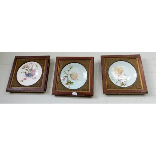 133 - Four framed floral decorated plaques, one damaged