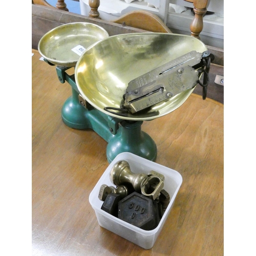 150 - A set of kitchen scales with brass pans and weights and two Salters spring balance scales