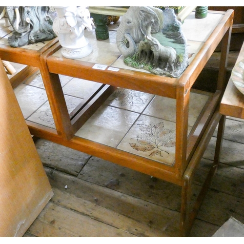 162 - A long teak coffee table with tiled top and a pair of matching square tables