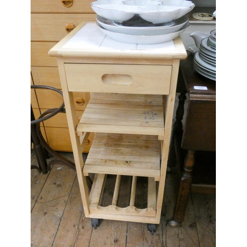 167 - A small white tile top kitchen workstation with shelves and wine rack under, 15