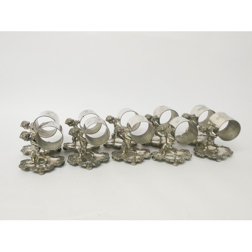 535 - Ten silver plate napkin ring holders supported by cherubs on fancy bases