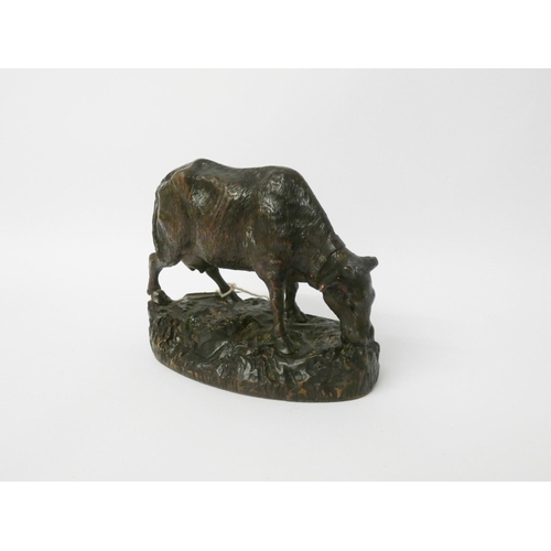 514 - A small carved black forest cow ornament, 5 1/2