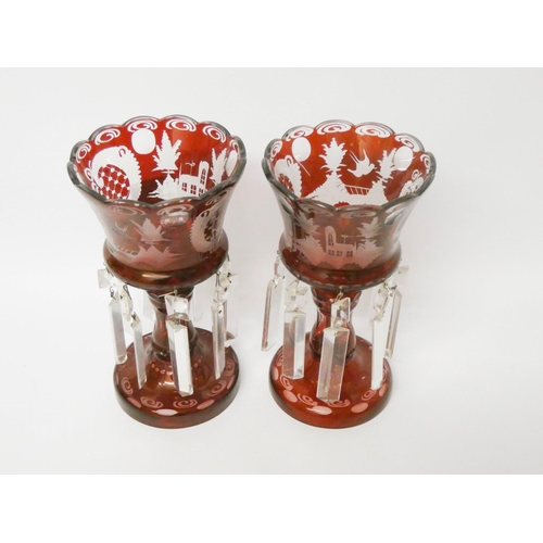 525 - A pair of Bohemian ruby glass lustre candlesticks, approximately 9