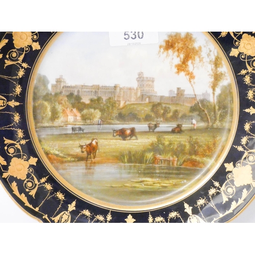 530 - A Sevres style blue and gilt bordered porcelain plate decorated with landscape castle scene,  9 1/4