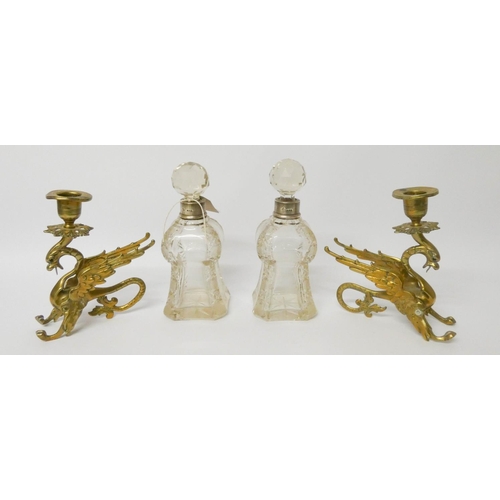 542 - A pair of shaped and cut glass silver mounted small decanters and a pair of brass Griffin candlestic... 