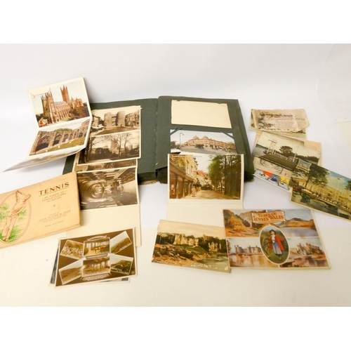 555 - A postcard album containing over 150 postcards mostly of topographical views together with a few com... 