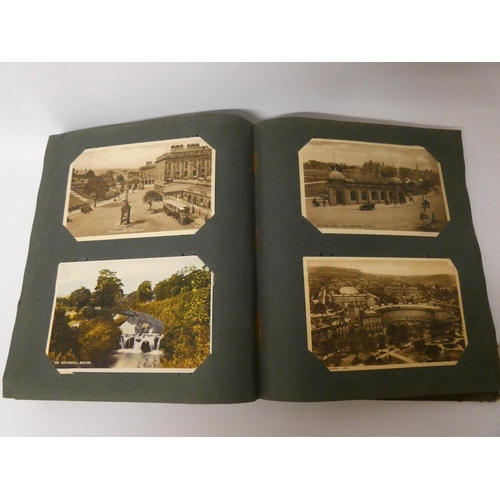 555 - A postcard album containing over 150 postcards mostly of topographical views together with a few com... 