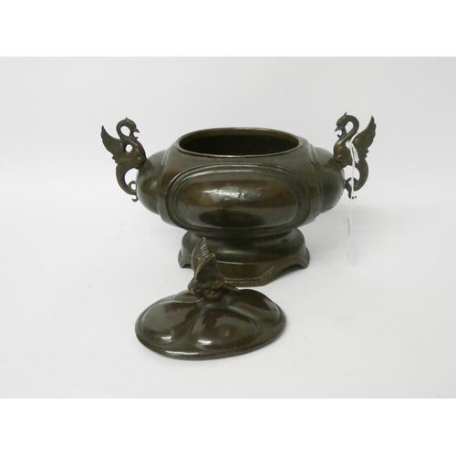 561 - A Japanese bronze oval bowl with cover with winged dragon handles, overall width 8 1/2