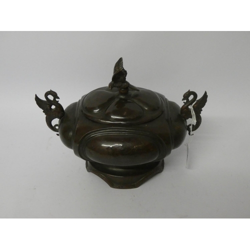 561 - A Japanese bronze oval bowl with cover with winged dragon handles, overall width 8 1/2