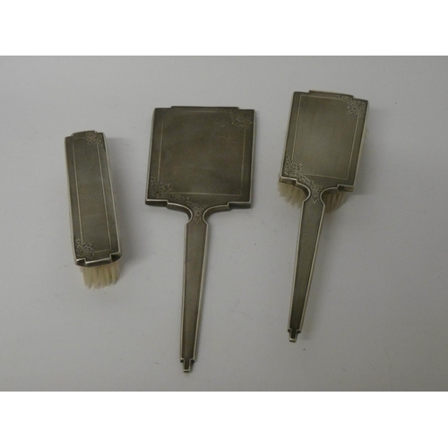 599 - Three piece silver backed engine turned hairbrush set with hand mirror together with fitted case