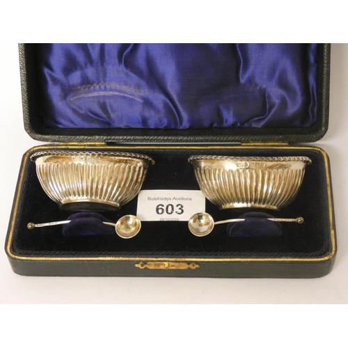 603 - A pair of silver oval salt cellars with spoons in fitted box. with blue glass liners, Birmingham 190... 