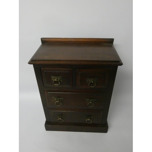 773 - An Edwardian miniature mahogany chest of two long and two short drawers