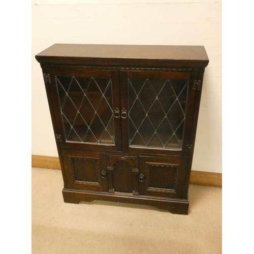 791 - A reproduction oak low leaded glazed two door bookcase with cupboards under,  2'9 wide