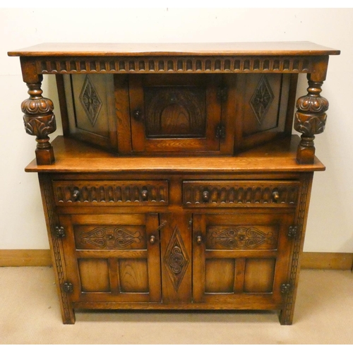 794 - A reproduction oak Court cupboard with carved door panels, by Bevan-Funnel (furniture of distinction... 