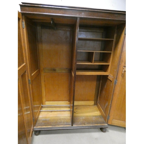 805 - A 1930's oak compaction style two door wardrobe fitted inside, 4' wide