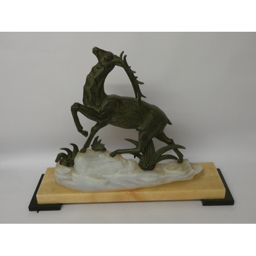 873 - A 1920 French bronze effect red deer on white onyx and marble base, 22