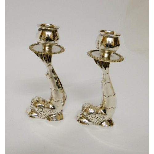 572 - Silver plated egg cruet, pair of heavy dolphin plated candlesticks, small plated cockerel and a bras... 