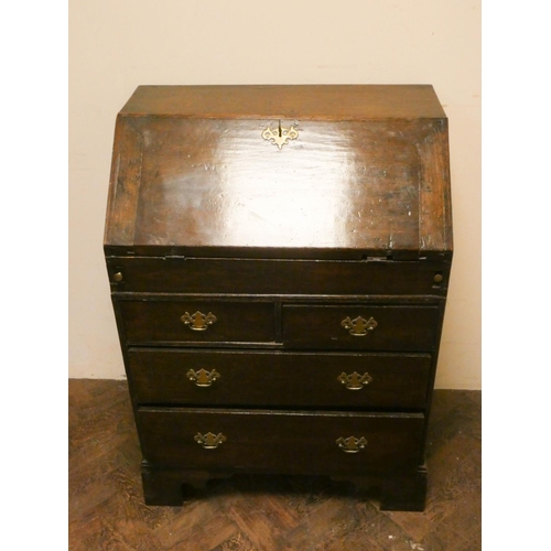 897 - A small 18th century oak bureau fitted with pigeon hole and well with two long and two short drawers... 