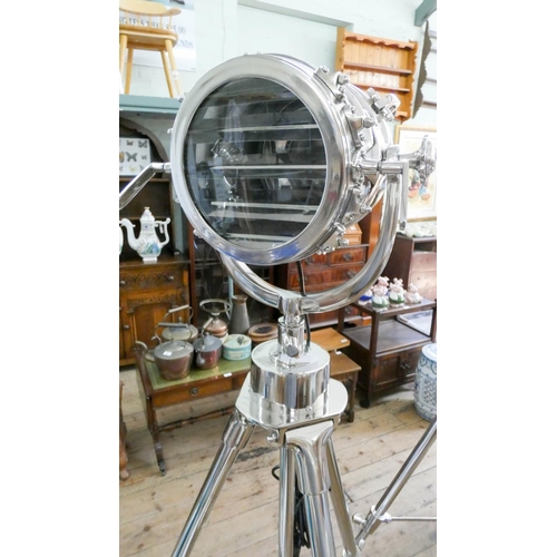 106 - An industrial search light style steel spotlight on adjustable tripod base