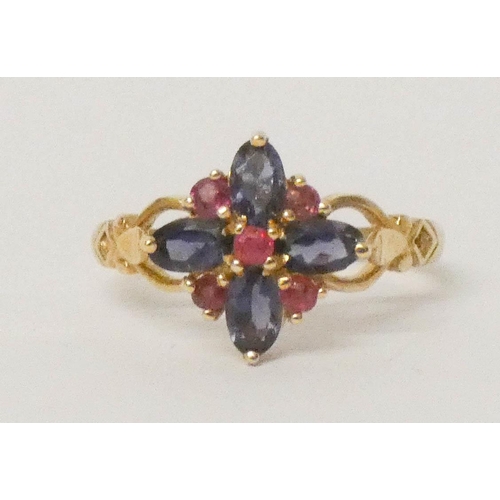 637 - A ruby and illite cluster ring set in a quatrefoil design, 9ct gold hallmarked band, ring size P