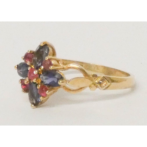 637 - A ruby and illite cluster ring set in a quatrefoil design, 9ct gold hallmarked band, ring size P