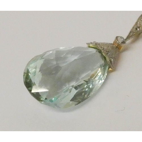 683 - An aquamarine pendant, set with a tear drop aquamarine with diamond set pave mount, on fine 14ct gol... 