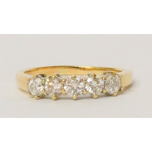 689 - A five stone diamond half hoop ring, set with five uniform diamonds of approximately 1 carat total w... 