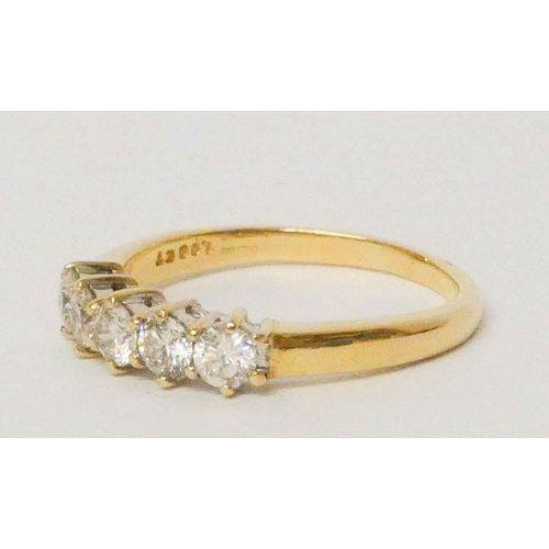 689 - A five stone diamond half hoop ring, set with five uniform diamonds of approximately 1 carat total w... 