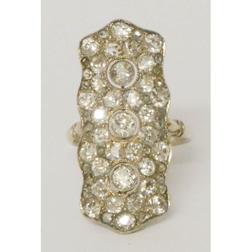 690 - An impressive antique diamond plaque ring
set with pave set diamonds in a stylised trio of flower he... 