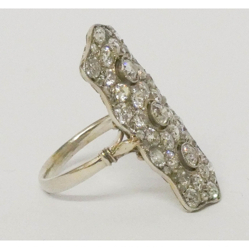 690 - An impressive antique diamond plaque ring
set with pave set diamonds in a stylised trio of flower he... 