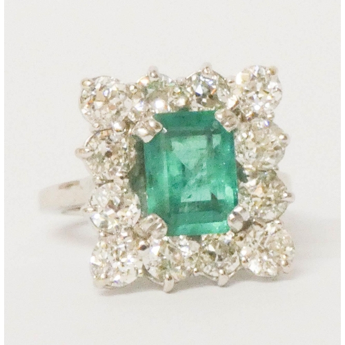 698 - An impressive emerald and diamond ring, of square design, the central emerald measures 10mm x 8mm ap... 