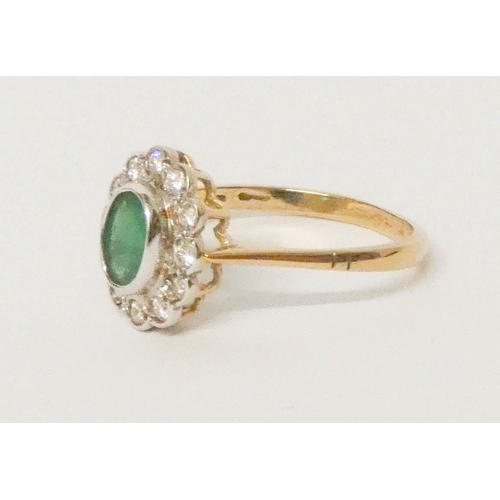 700 - An oval emerald and diamond cluster ring, on 9ct yellow gold band, ring size R