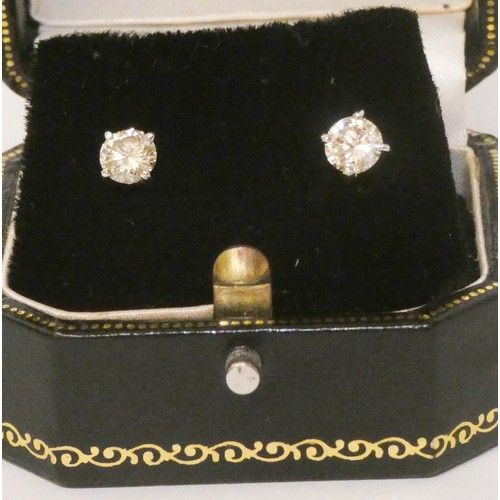 691 - A pair of solitaire diamond ear studs, each set with a claw set circular brilliant cut diamond of 0.... 