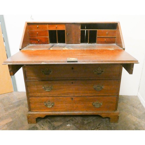 914 - A Georgian mahogany bureau with four long drawers under standing on bracket feet , 3' wide