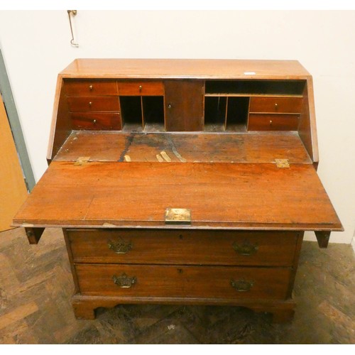 914 - A Georgian mahogany bureau with four long drawers under standing on bracket feet , 3' wide