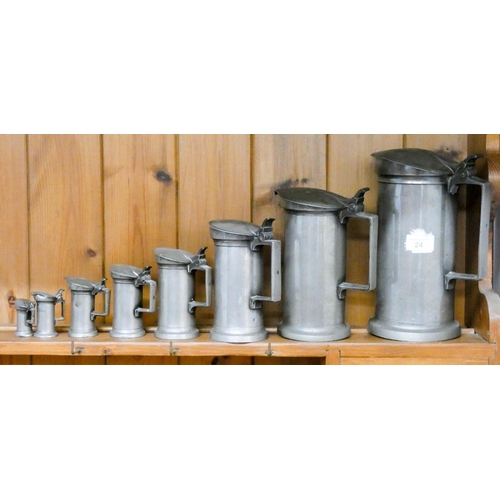 24 - Set of eight lidded graduated pewter tankards
