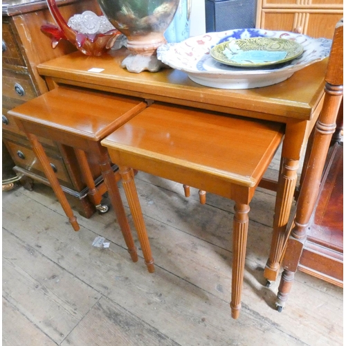 47 - Nest of three teak coffee tables on reeded legs