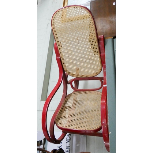 23 - A pair of round seat Bentwood chairs and a red painted rocking elbow chair with cane panel seat and ... 
