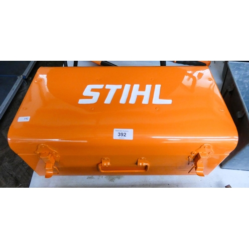 An orange Stihl metal tool box