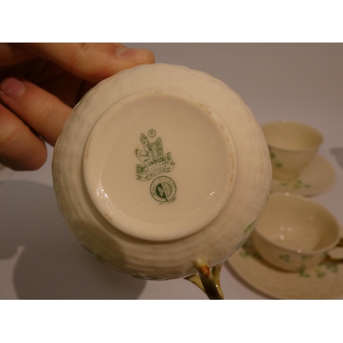 545 - Belleek shamrock decorated tea ware, comprising of four cups, four saucers, cream jug and sugar bowl... 