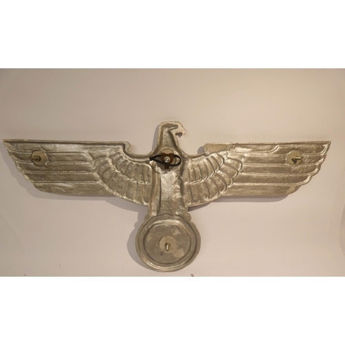 527 - A post Second World War Nazi eagle and Swastika in cast aluminium, overall length 25