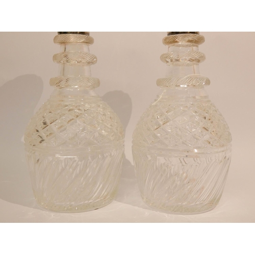 533 - A pair of cut glass decanters with silver rims, each 10