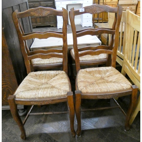 56 - A set of four French ladder back style dining room chairs with rush seats